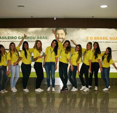 a group of people standing in front of a large poster