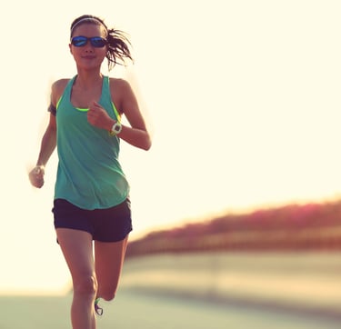 Woman running outside with sunglasses
