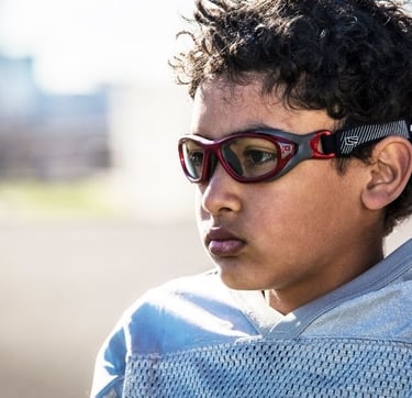Child wearing safety sports goggles