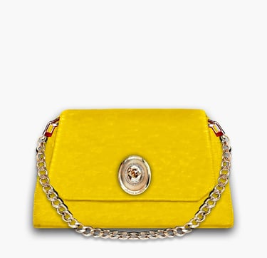 Vibrant yellow designer clutch bag with a gold chain strap and ornate metal emblem.