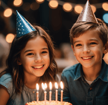 a boy and girl are sitting at a table with candles