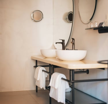 a bathroom with a sink and a mirror in a hotel.Market Positioning for Tourism with Timea Pokol
