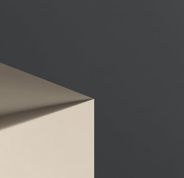 A sharp, minimalist architectural detail of a structural corner where light meets shadow. The composition is clean with ample whitespace, using charcoal #333333 and soft sand #F9F7F2 tones. The style is professional and philosophical, capturing the silent dialogue between matter and the human experience.