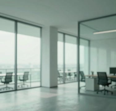 A high-resolution, wide-angle shot of a minimalist, modern office interior with large glass windows and clean geometric lines. The lighting is soft and natural. The scene features a palette of muted greens (#3F5E5C) and soft teals (#A7C5C3), conveying a sense of calm and professional focus for vasii.eu.