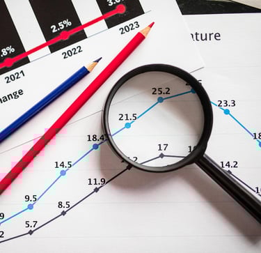 magnifying glass highlighting investing chart symbolizing gold market for precious metals