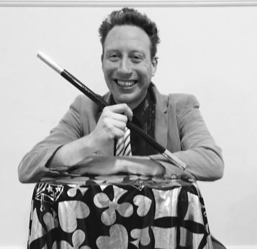 a man in a suit and tie is smiling and holding a knife and knife