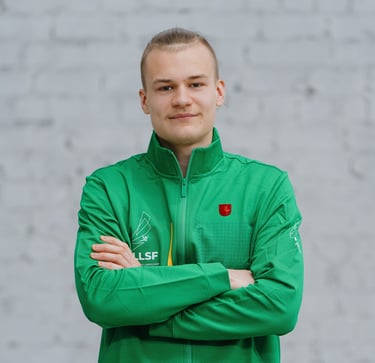 a man in a green jacket and crossed arms
