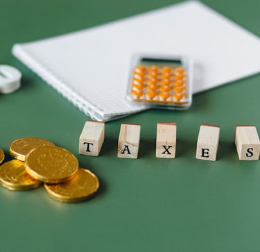 gold coins, calculator and word taxes show gold ira taxes and learning potential tax benefits