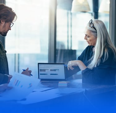 a group of people sitting around a table with papers and papers