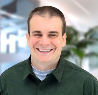 a man in a green shirt smiling at the camera