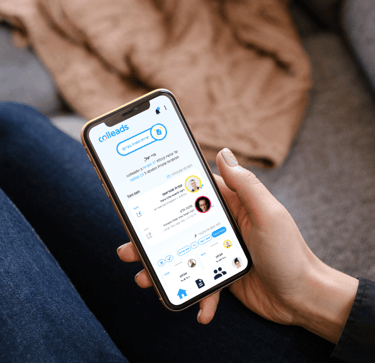 woman's hand holding a smartphone with the colleads app's main screen on it