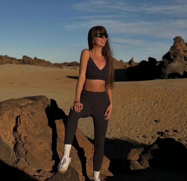 a woman in a black bra top and leggings