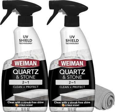 Two bottles of Weiman Quartz and Stone 2-in-1 cleaner and protector spray with a microfiber cloth.