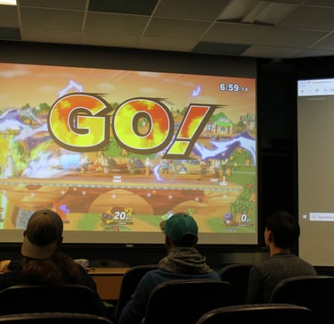 Penn State IEEE student members at a social event playing video games