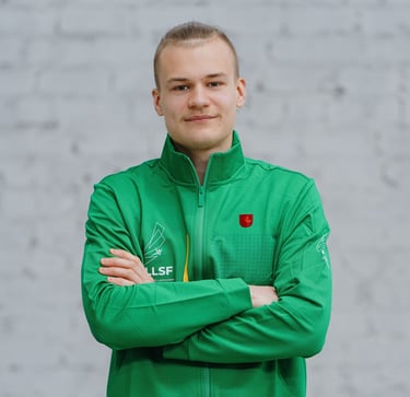 a man in a green jacket and crossed arms
