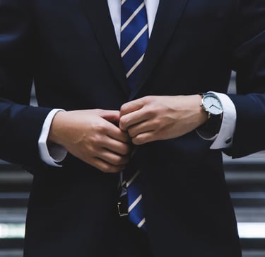 gold ira company worker with suit on in front of stairs representing choosing the right gold ira company