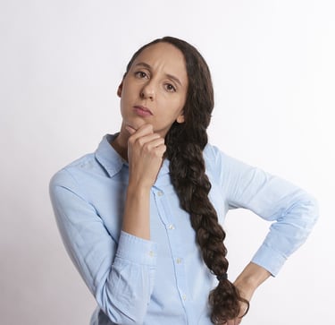 woman thinking thoroughly and wondering if gold ira is a scam
