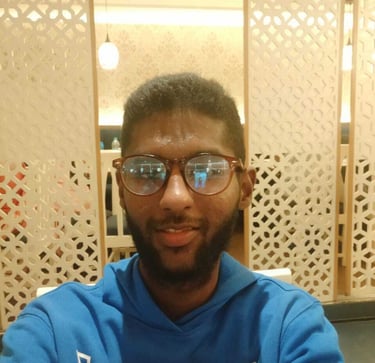 a man in a blue sweatshirt and glasses