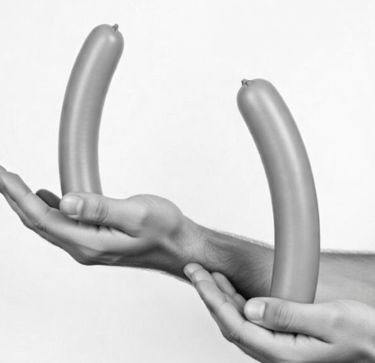 2 hands open palmed with a sausage in each hand