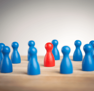 a single red pawn surrounded by blue pawns