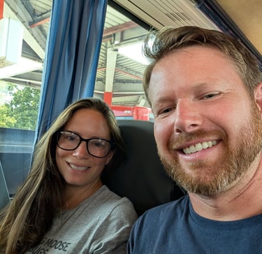 Moose and Bugs taking a selfie while sitting together on a passenger bus during a trip.