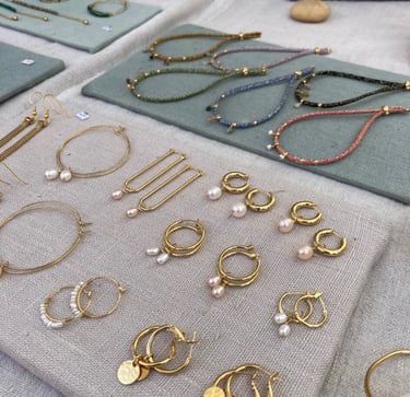a table with a lot of handmade jewelry