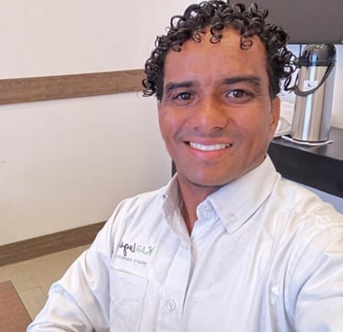 a man in a white shirt and a coffee maker