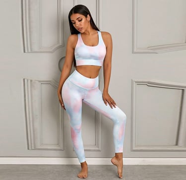 Woman wearing a pastel tie-dye yoga set with a sports bra and high-waisted leggings.