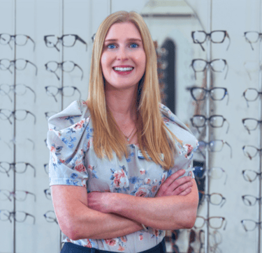 Shonag Laird Optometrist Smiling woman with long strawberry blonde hair and blue eyes