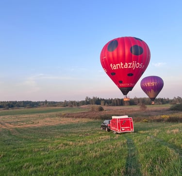 a red hot air balloon in the air vilnius