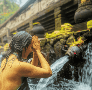 a woman in a bikini top standing in a river