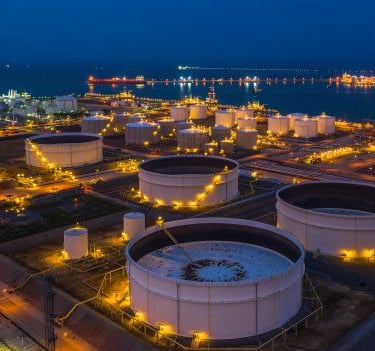 a large tank of oil tanks with lights on