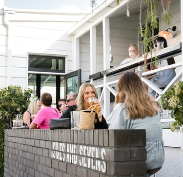 Two female guests are dining on a restaurant terrace