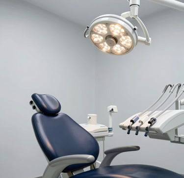 Modern ergonomic dental unit chair with overhead LED operating light, chrome and white sterile finishes, soft clinical lighting