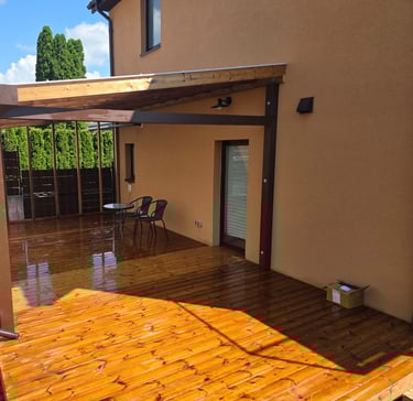 a patio with a wooden deck and a table with chairs