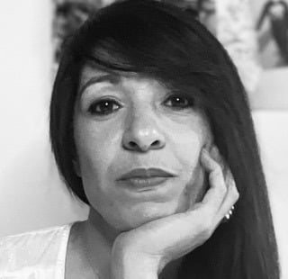 a woman with long hair and a white shirt