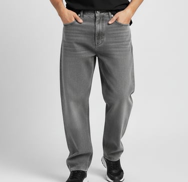 a man in a black shirt and jeans standing in front of a white wall