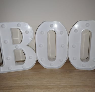 White LED marquee letters spelling "BOO" with glitter finish, perfect Halloween decoration for home,