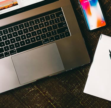 a laptop and a notebook on a table.Revenue Management for Hotels with Timea Pokol Consultant