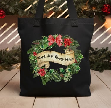 Black tote with poinsettia wreath and “Plant Joy. Share Peace” — botanical holiday bag by Miss Chatty Plants