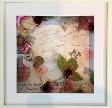 a memory box with keepsakes and a preserved wedding bouquet in a frame