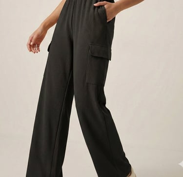 a woman in a cropped top and pants with a cropped top