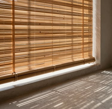 Premium bamboo blinds filtering warm sunlight onto a minimalist concrete balcony floor