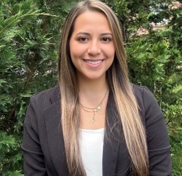a woman in a black jacket and white shirt named claudia cardona