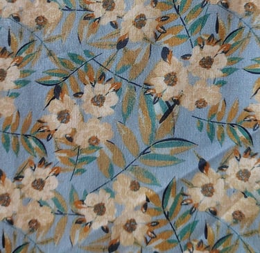 a blue floral print fabric with a bird on it