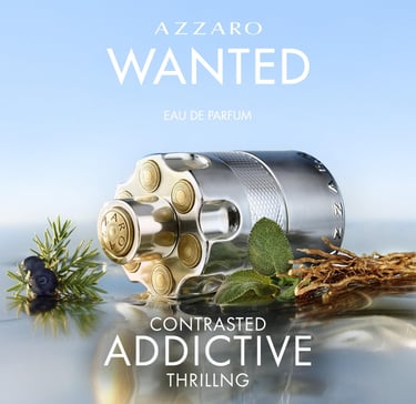Azzaro Wanted Eau de Parfum bottle shaped like a revolver cylinder with woody and herbal ingredients.