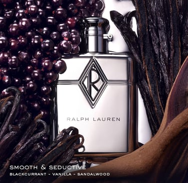 Ralph Lauren silver perfume bottle surrounded by blackcurrant berries and vanilla beans.