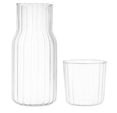 Glass carafe and matching tumbler set on white background
