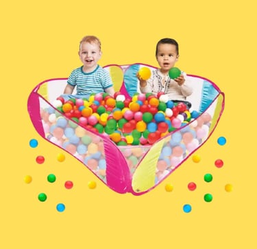 two babies playing in a ball pit with balls