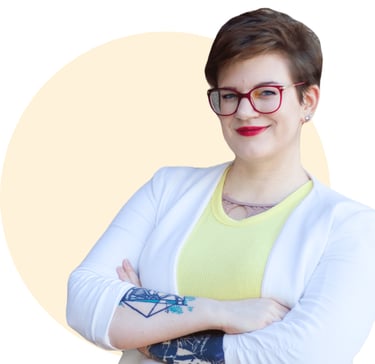 Swana Schuchmann, with a tattoo on her arm and a yellow shirt, smiling